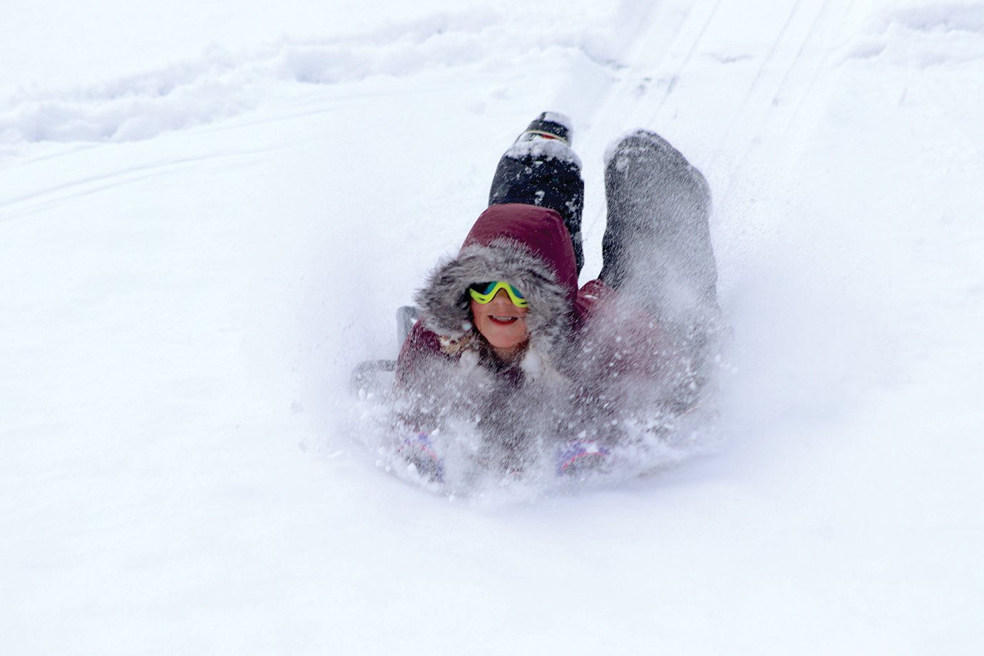 Eleven-year-old Mabel Hoar tries to avoid a face full of snow as she sleds; however, sometimes it's necessary, she said.